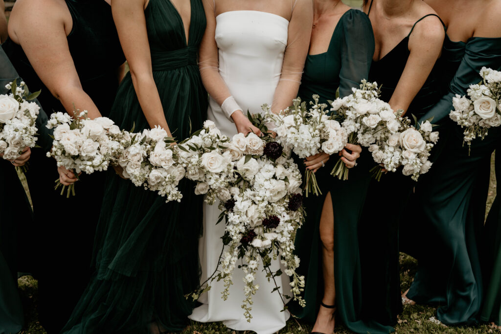 Bridal and bridesmaids’ green and white bouquets at modern romantic Catskills wedding