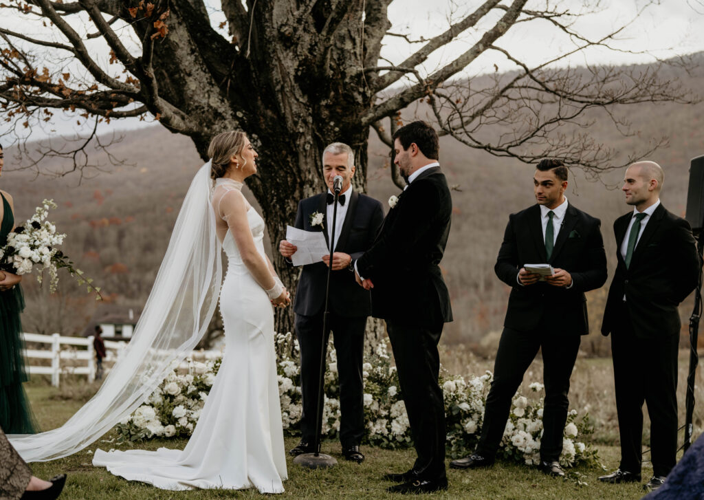 Grounded floral arch ceremony setup at modern romantic Catskills wedding