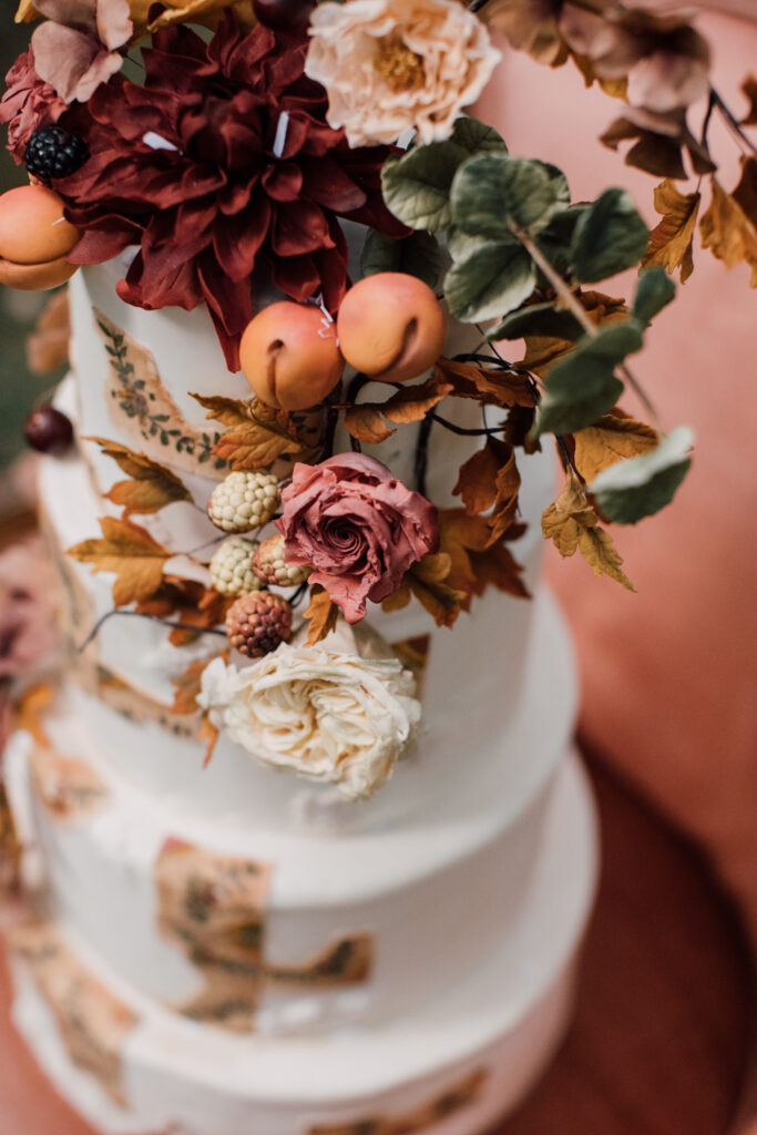 Peach and copper-themed wedding cake by Mamie Brougitte Cakes at a Roxbury Barn and Estate wedding