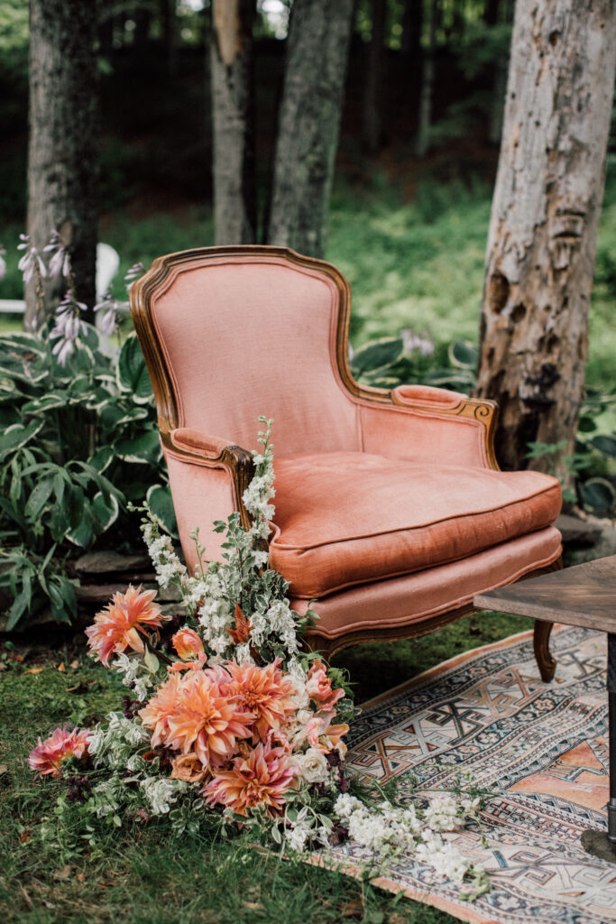 Vintage lounge setup with velvet seating and floral accents at a Roxbury Barn and Estate wedding reception