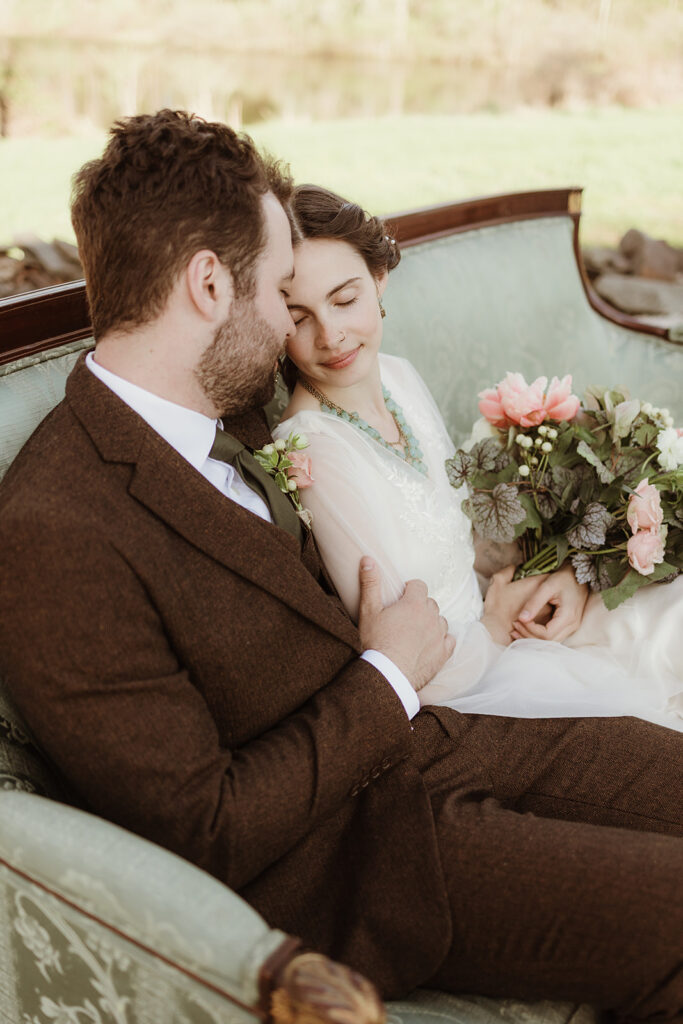 Bride and Groom snuggle on a mint green Belle-Epoque wedding lounge at an Art Nouveau wedding in NY