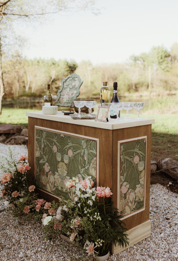 Custom-designed wooden wedding bar with Alphonse Mucha-inspired peony motif, blending Art Nouveau artistry with functional elegance.