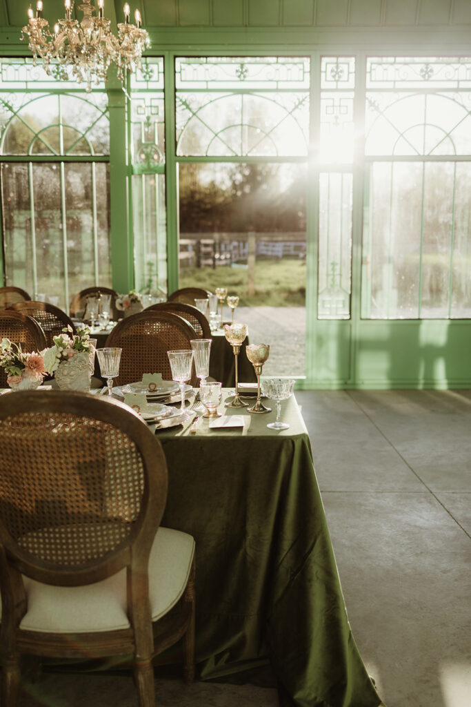 L'Orangerie greenhouse wedding venue in Greenville NY, with green velvet tablecloths chandeliers