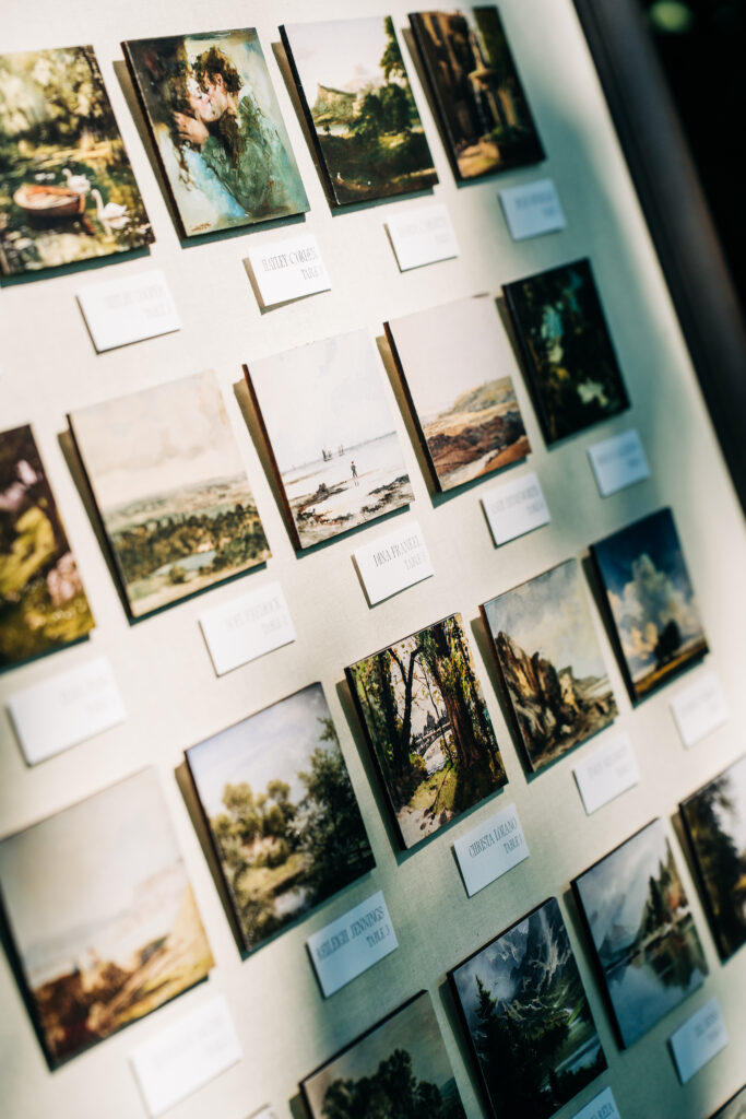 Miniature canvases on an easels serve as a wedding seating chart