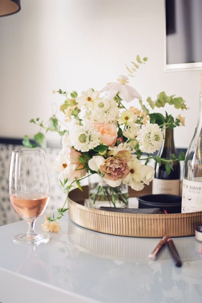 wedding cocktail bar with peach and yellow floral arrangement